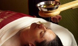 Kabuki Shirodara Treatment, a warm, gentle stream of oil poured on the forehead and scalp to calm the mind.